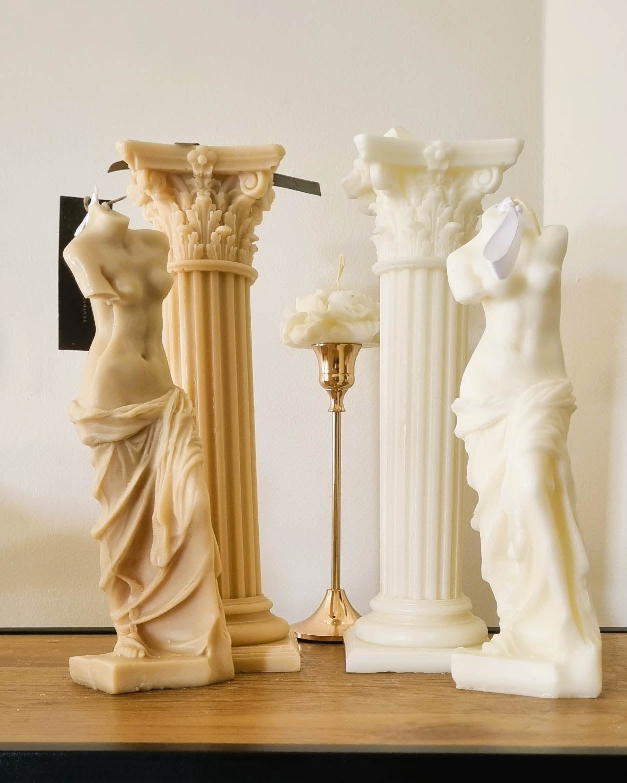 Beige and white Sculpted candle embodying Aphrodite's body, radiating inspired sophistication and sensuality.